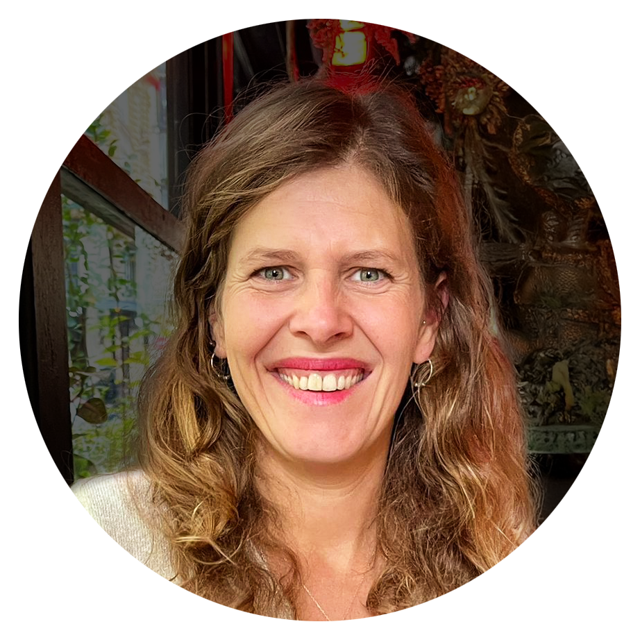 Black-and-white portrait of the business founder, Jenny Souto, smiling, with a relaxed and approachable expression.